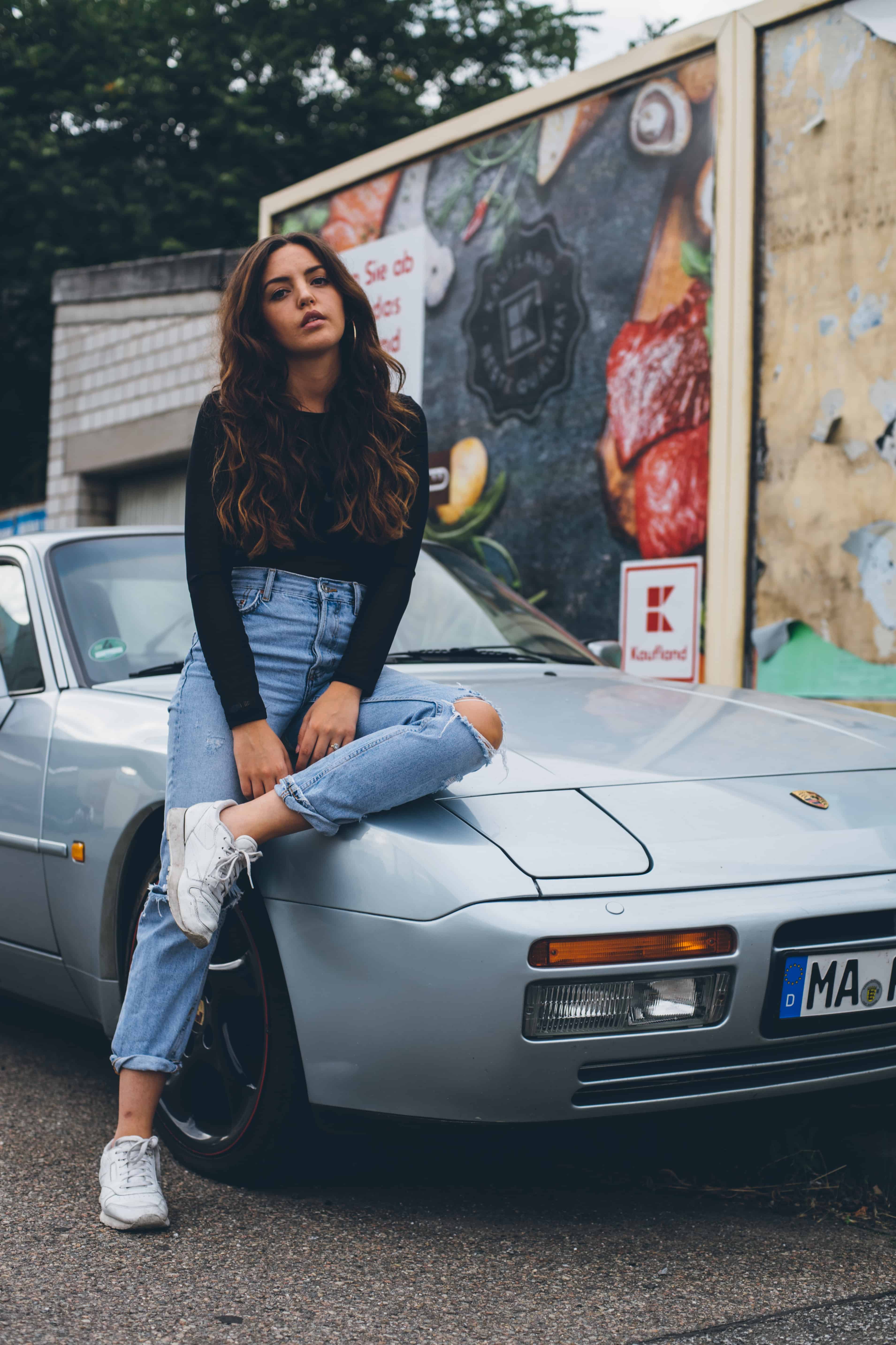 Porsche 944 with Woman Sitting on Hood